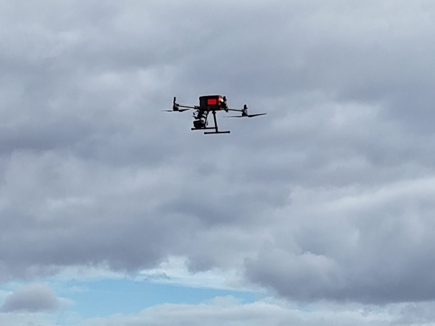 Survey drone flying against a cloudy sky over Sussex