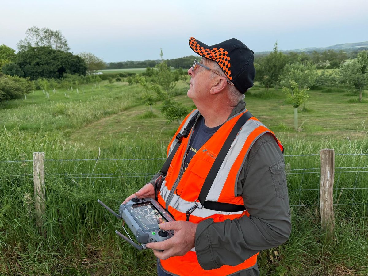 Robert Wallace operating a drone controller in a field